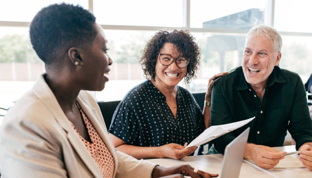 two-women-and-man-going-over-paper-work.jpg