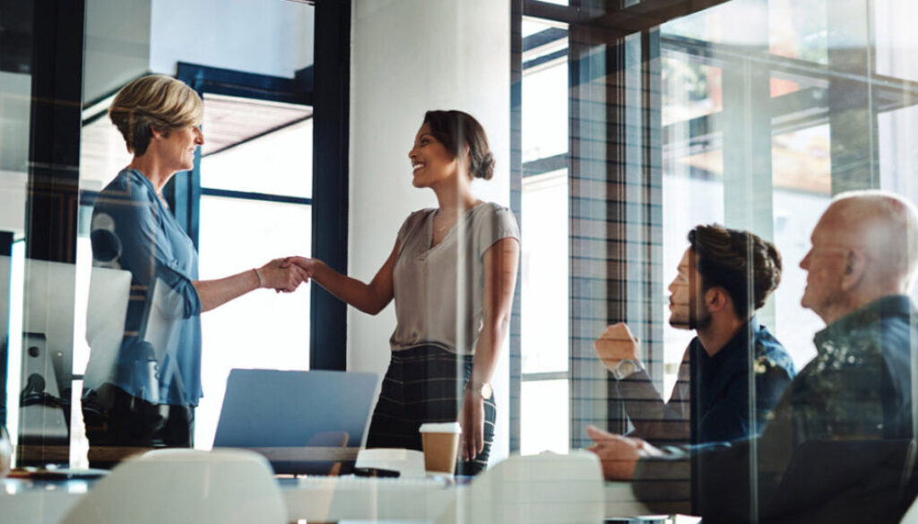 two-people-shaking-hands-in-modern-office-setting.jpg